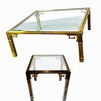 Combined view of square coffee table and smaller side table showing brass frames with Greek key motif and glass tops