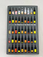 Front cover of the book '101 Whiskies to Try Before You Die' showing colorful whisky bottle illustrations.