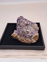 Top and angled view of amethyst crystal clusters on a stone base