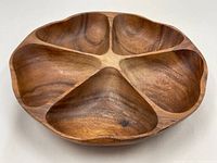 Top-down view of the round vintage Monkey Wood Lazy Susan showing the five triangular compartments and the wood grain pattern.