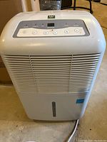 Front view of white Westpointe dehumidifier showing air intake grill and control panel on top.