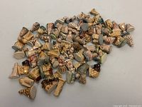 Top-view photo showing a large collection of assorted WADE porcelain miniature figurine pieces scattered on a flat surface.