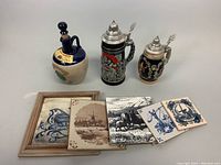 Various ceramic items including Kings Ransom whiskey bottle, two German beer steins with pewter lids, and decorative tiles