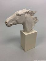 Side angle showing detailed horse head sculpture with textured mane and smooth rectangular base.