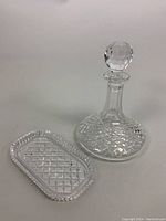 Decanter and serving dish with diamond cut pattern, stopper lid on decanter visible