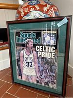 Full view of framed Sports Illustrated 'Celtics Pride' print featuring Larry Bird in Celtics uniform, signed, front view.