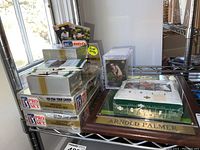 Overview of lot showing Arnold Palmer plaque and trading card boxes