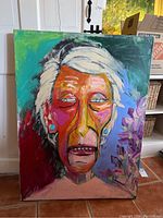 Full view of painting showing elderly abstract portrait and part of room interior