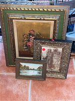Three framed art prints grouped showing floral still life, a river landscape with fisherman, and a figurative sketch. Variety of frame styles and sizes.