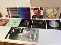 Photo showing all eleven albums laid flat on a table with some overlap, visible album covers including Ringo Starr and Heart.
