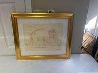 Framed elephant drawing resting against wall, showing full view of the artwork and frame, highlighting overall size and presentation.