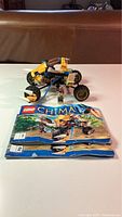Photo showing assembled Lego Chima vehicle, instruction manual folded and placed flat
