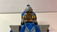 Close-up of pilot mini figure seated in cockpit of Anakin's Podracer showing helmet and goggles details.