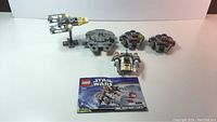 Five Lego Star Wars Micro Fighters including Millennium Falcon, Y-Wing, and others with instruction manual.