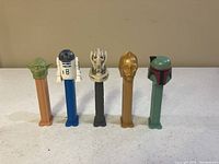 Full view of all five Star Wars PEZ dispensers lined up showing characters Yoda, R2-D2, General Grievous, C-3PO, and Boba Fett