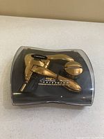 Plastic display box packaging containing the gold titanium plated corkscrew opener with Rabbit branding and product details visible on the insert.