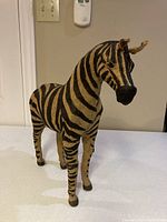 Front and angled view of the burlap zebra ornament showing texture and detailing.