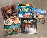 Photo of all five vinyl records with original album covers laid out on the floor