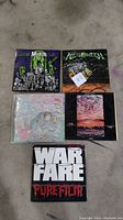 Five vinyl records arranged in two rows: top row has Misfits Earth A.D., Helloween, Split Enz albums; bottom row has Title And and Warfare Pure Filth albums.
