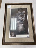 Framed lynx print showing full frame and matting with auction sticker.