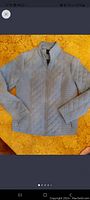 Northern Reflections light blue quilted jacket, medium size, laying flat on surface