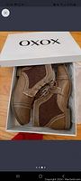 Pair of brown XOXO boots in original white box with brand logo on lid.