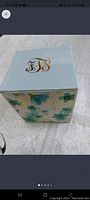 Royal Luxe soy candle box with floral design and gold monogram initials