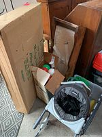 Shot showing boxed Chicco play yard, wooden changing table, and box with colorful balls