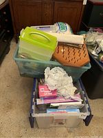 Top view of three stacked storage bins containing crafting materials with some items visible on top such as fabric batting and a hexagonal wooden peg board.