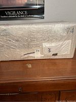 Photo showing the packed item inside bubble wrap, confirming it is new and unassembled.