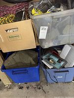 Overview of boxes and bins containing hardware items including ropes, heater, vent coils, and miscellaneous parts