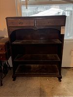 Front view of bookshelf showing two drawers and three open shelves