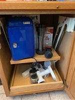 Blue Vector ice crusher with cord, KitchenAid attachments in drawer below