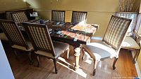 Eight chairs around dining table: full lot view
