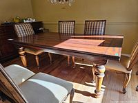 Front three-quarter view of full table with chairs pushed in