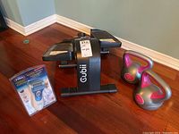 Cubi stepper with two kettlebell weights and Dr Scholl's Express Pedi foot smoother visible on floor