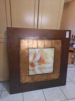 Front angle view of the Gabriel Scott floral print on canvas showing the textured gold border and dark brown outer frame with soft pastel floral design.