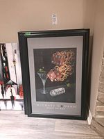 Photo showing two of the framed prints leaning against the wall, highlighting the artwork and frames.