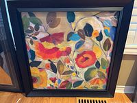 Framed floral artwork by Kim Parker showing multi-colored flowers and leaves with black frame.