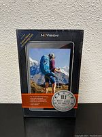 Front of sealed box showing NūVision branding, image of tablet with a hiker, 10.1 inch HD display noted.