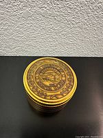 Top view showing embossed gold-tone seal for The County of Santa Clara with laurel wreath design and textured sides.