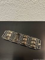 Full view of the vintage zebra print clasp bracelet laying flat to show the entire piece and design details.