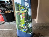 Closeup of the product box highlighting features and dimensions—12 by 12 feet shelter size, beige with mesh side shield.