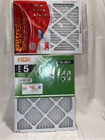 Photo showing the 3M Filtrete 1085 Micro Allergen Extra filter and HDX FPR 5 Dust & Pollen filter packaged and new, size 16x20x1