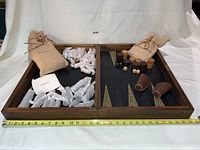 Full view of wooden foldable game board opened showing both chess and backgammon playing surfaces with pieces and pouches arranged inside.
