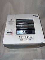 Front view of the boxed pasta maker showing the model name and pasta types (Lasagna, Fettuccine, Tagliolini)