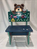 Front view of the children's wooden bench with bear and 'Time Out' design on the backrest.