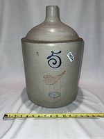 Front view of large Red Wing stoneware jug showing blue number 5, brown wing emblem, and Red Wing Union Stoneware Co oval stamp.