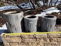 Front view of three faux birch planters with measuring tape showing nearly 30 inches total width.