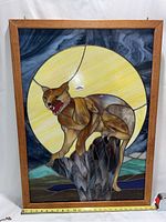 Full view of stained glass panel showing mountain lion on rock with moon and landscape.